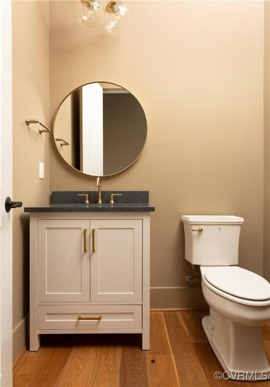 2005 Southcliff Rd, Richmond, VA 23225 - bathroom featuring baseboards, wood finished floors, toilet, and vanity