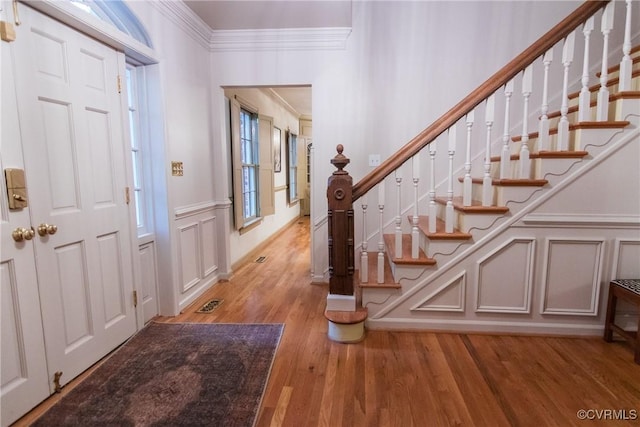 4709 Perdue St, Chester, VA 23831 - foyer featuring ornamental molding, a decorative wall, light wood finished floors, stairs, and wainscoting