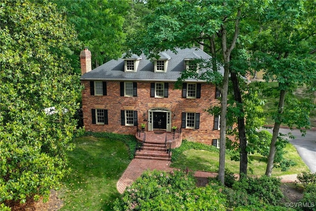 4709 Perdue St, Chester, VA 23831 - view of front facade featuring a chimney, brick siding, and a front yard
