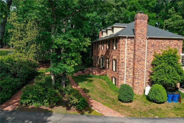 4709 Perdue St, Chester, VA 23831 - view of side of property with brick siding, a chimney, and a shingled roof