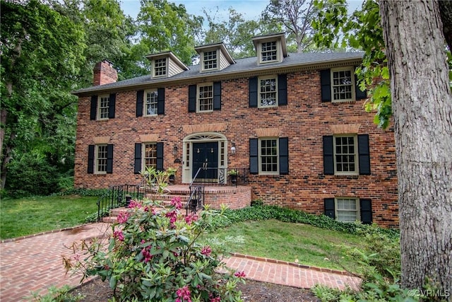 4709 Perdue St, Chester, VA 23831 - view of front of property with brick siding, a front yard, and a chimney