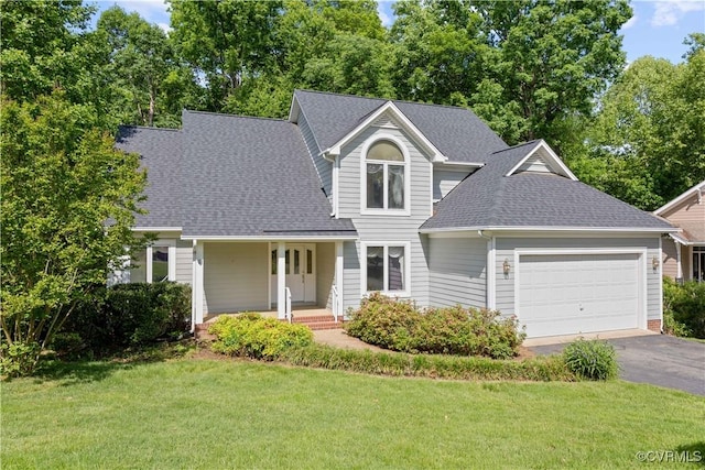 view of front of property featuring a shingled roof, a garage, a front lawn, asphalt driveway, and covered porch