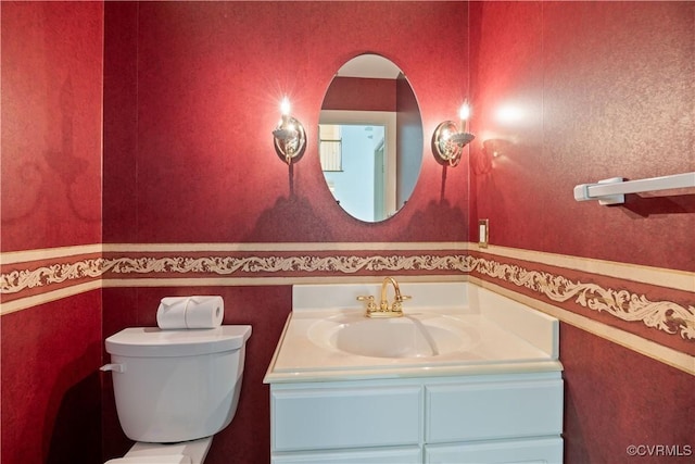bathroom with toilet and vanity