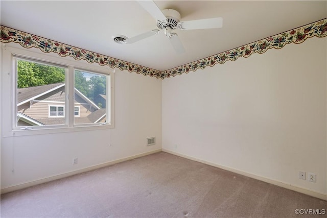 unfurnished room with carpet flooring, baseboards, and ceiling fan