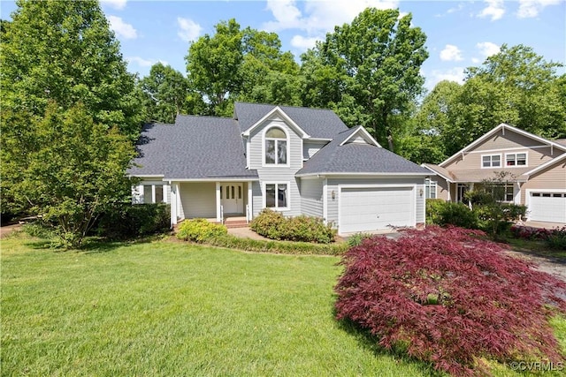 traditional-style house with an attached garage, a front yard, and roof with shingles