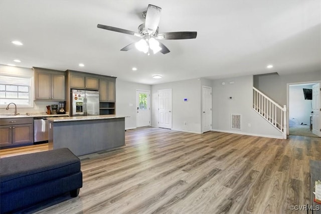 3704 Burnham Dr, Hopewell, VA 23860 - kitchen with open floor plan, appliances with stainless steel finishes, a sink, a center island, and light countertops