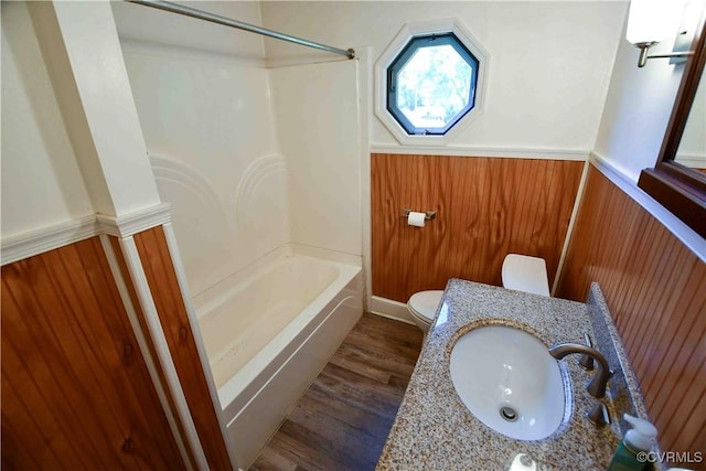 612 S Broad St, Kenbridge, VA 23944 - bathroom with wainscoting, toilet, wood finished floors, shower / tub combination, and vanity