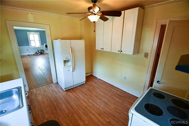 612 S Broad St, Kenbridge, VA 23944 - kitchen featuring white appliances, ornamental molding, white cabinets, light wood-style flooring, and a ceiling fan