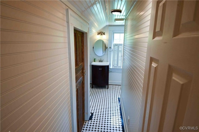 612 S Broad St, Kenbridge, VA 23944 - hall featuring a sink, wooden walls, and tile patterned floors
