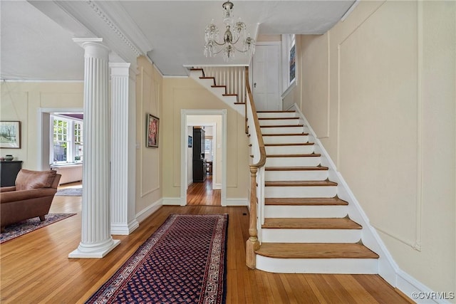 3201 Kensington Ave, Richmond, VA 23221 - stairway with wood-type flooring, decorative columns, ornamental molding, a chandelier, and baseboards
