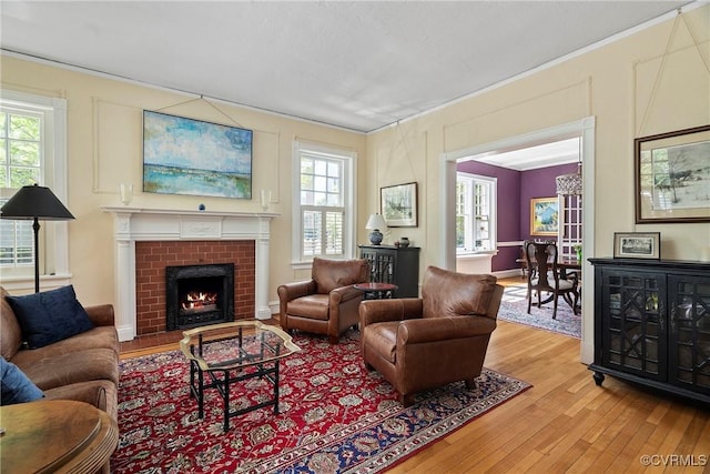 3201 Kensington Ave, Richmond, VA 23221 - living area with light wood-style floors, ornamental molding, and a fireplace