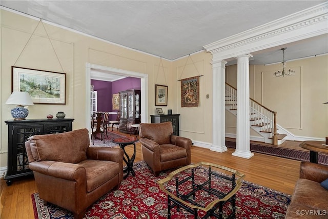 3201 Kensington Ave, Richmond, VA 23221 - living room with ornate columns, wood finished floors, ornamental molding, stairs, and baseboards