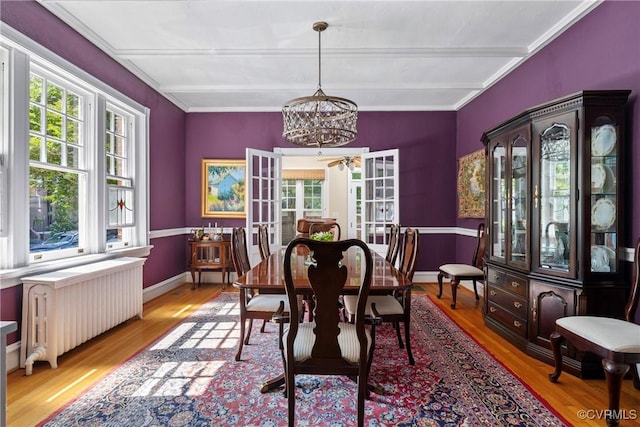 3201 Kensington Ave, Richmond, VA 23221 - dining space with radiator heating unit, wood finished floors, a chandelier, beam ceiling, and baseboards
