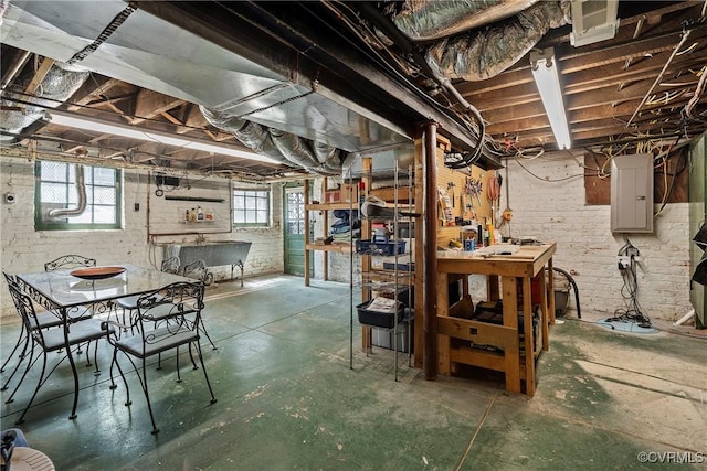 3201 Kensington Ave, Richmond, VA 23221 - basement featuring brick wall, a workshop area, and electric panel