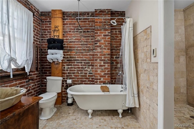 3201 Kensington Ave, Richmond, VA 23221 - full bath featuring brick wall, a soaking tub, tiled shower, and toilet