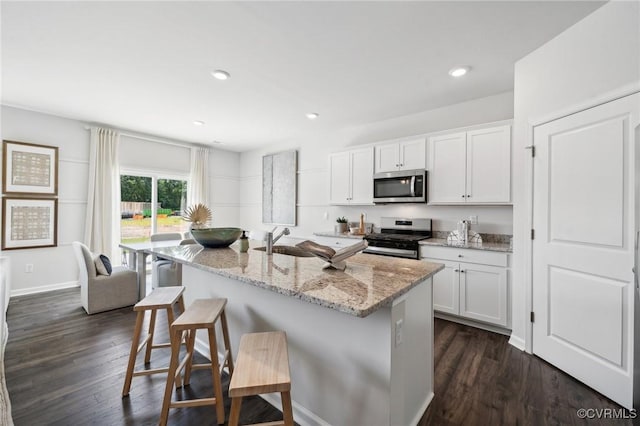 7006 Sanguine Mews, Chesterfield, VA 23234 - kitchen with appliances with stainless steel finishes, a sink, a kitchen bar, light stone countertops, and recessed lighting