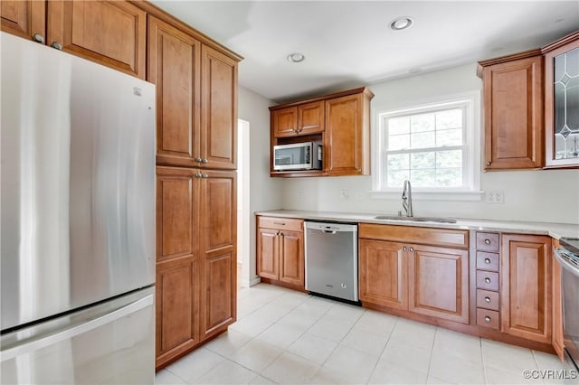 2206 Milbank Rd, Glen Allen, VA 23229 - kitchen featuring appliances with stainless steel finishes, a sink, brown cabinets, light countertops, and recessed lighting