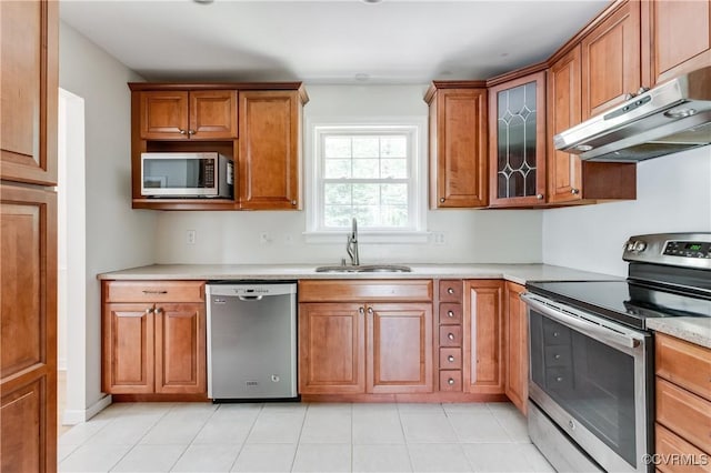 2206 Milbank Rd, Glen Allen, VA 23229 - kitchen with stainless steel appliances, a sink, under cabinet range hood, and brown cabinetry
