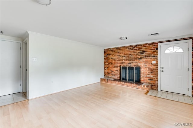 2206 Milbank Rd, Glen Allen, VA 23229 - unfurnished living room with crown molding, wood finished floors, and a brick fireplace