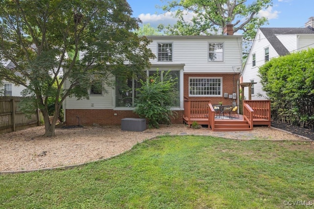 rear view of house featuring a wooden deck, a chimney, brick siding, and central air condition unit
