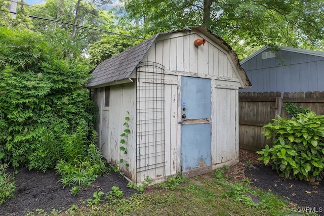 view of shed with fence