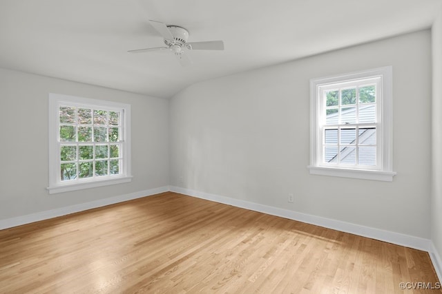 spare room featuring light wood-type flooring, baseboards, and ceiling fan