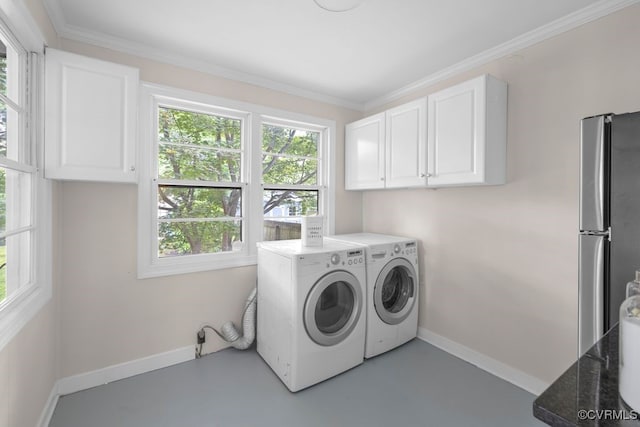clothes washing area featuring washer and dryer, ornamental molding, cabinet space, and baseboards
