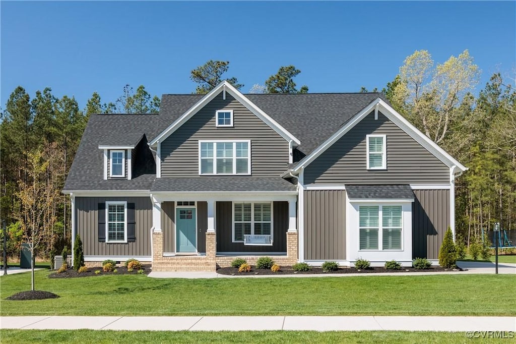 8748 Forge Gate Ln, Chesterfield, VA 23832 - craftsman house with board and batten siding, a front yard, and a shingled roof