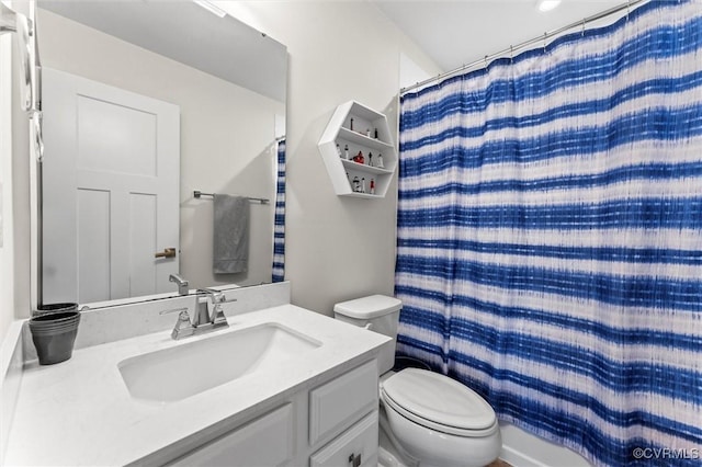 full bathroom with toilet, vanity, and curtained shower