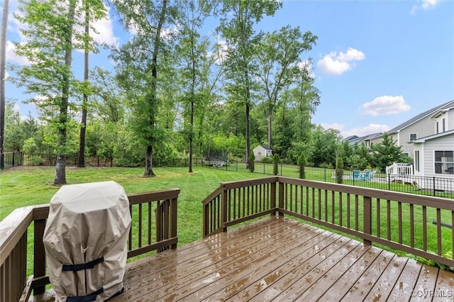 wooden deck with a grill