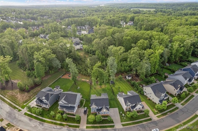 aerial overview of property's location with a forest and nearby suburban area