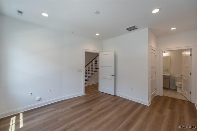 3327 Haydenpark Ln, Henrico, VA 23233 - spare room with wood finished floors, recessed lighting, and stairs