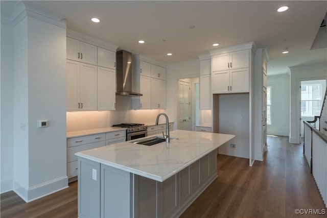 3327 Haydenpark Ln, Henrico, VA 23233 - kitchen featuring wall chimney exhaust hood, high end range, dark wood finished floors, white cabinets, and a kitchen island with sink
