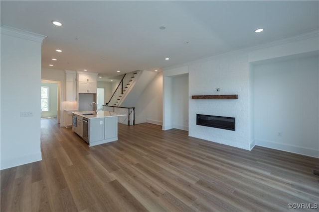 3327 Haydenpark Ln, Henrico, VA 23233 - kitchen with open floor plan, recessed lighting, a kitchen island with sink, light countertops, and a glass covered fireplace