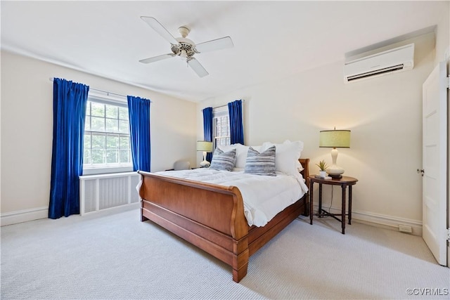 bedroom featuring carpet floors, a wall mounted air conditioner, a ceiling fan, and baseboards