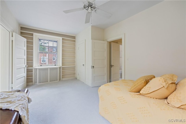 bedroom with carpet floors, ceiling fan, and radiator heating unit