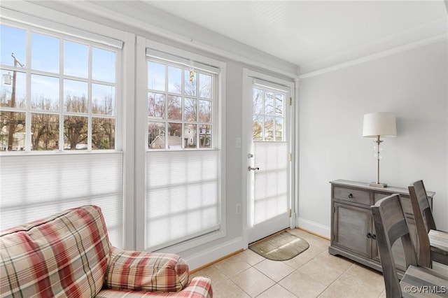 doorway to outside featuring light tile patterned floors, baseboards, and crown molding
