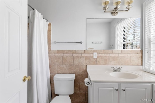 full bath featuring tile walls, toilet, and vanity