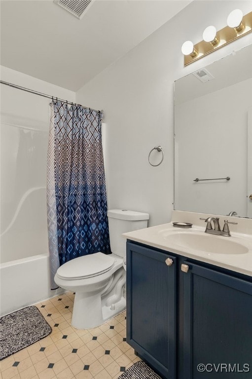 full bath featuring toilet, vanity, tile patterned flooring, and shower / bath combo