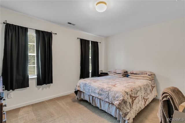 bedroom with carpet floors and baseboards