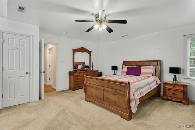 bedroom with light colored carpet, ceiling fan, and baseboards