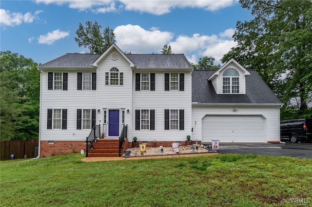 colonial house with an attached garage, driveway, and a shingled roof