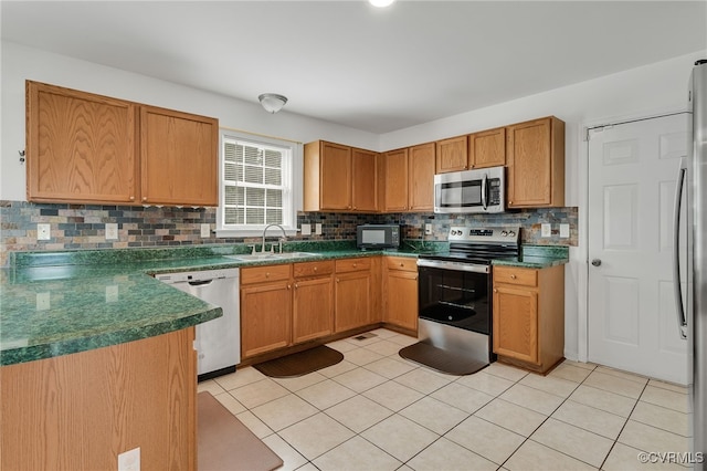 12027 Beaver Spring Ct, Midlothian, VA 23112 - kitchen with stainless steel appliances, backsplash, dark countertops, and light tile patterned flooring