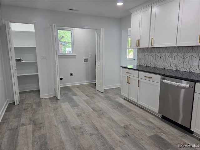 kitchen with dishwasher, dark countertops, tasteful backsplash, light wood finished floors, and recessed lighting