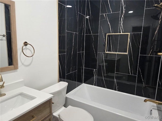 bathroom featuring toilet, vanity, and shower / bath combination