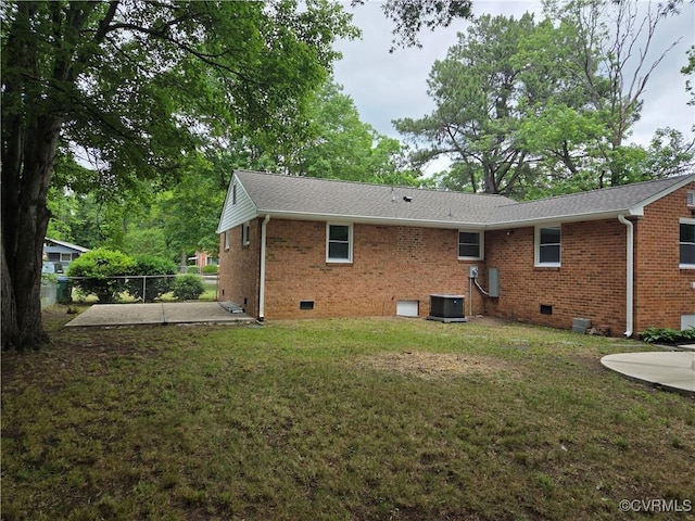 back of house featuring crawl space, brick siding, a patio area, and roof with shingles