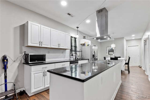 1201 W Broadway, Hopewell, VA 23860 - kitchen with island range hood, dark countertops, stainless steel appliances, white cabinets, and recessed lighting