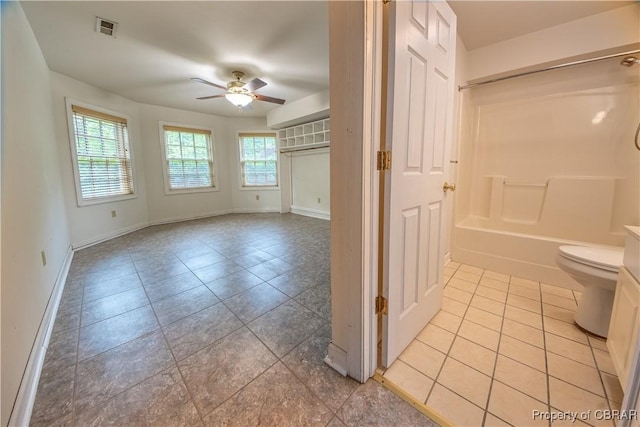 319 Parrotts Cove Rd, Water View, VA 23180 - bathroom with ceiling fan, tile patterned flooring, toilet, baseboards, and tub / shower combination