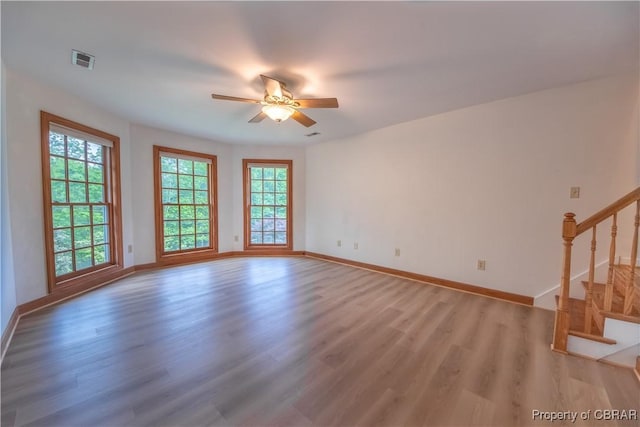 319 Parrotts Cove Rd, Water View, VA 23180 - spare room with stairs, light wood-style floors, a ceiling fan, and baseboards