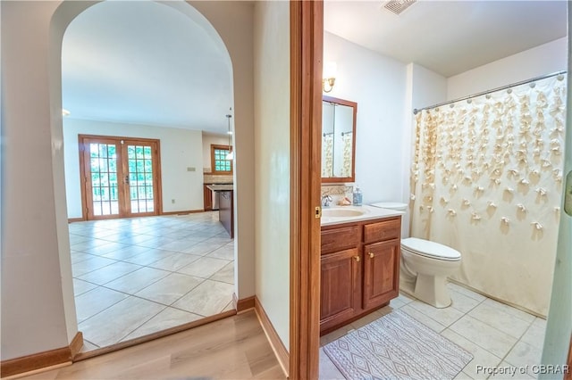 319 Parrotts Cove Rd, Water View, VA 23180 - bathroom with toilet, vanity, tile patterned flooring, and french doors
